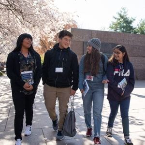 Latino students walking and talking on Congressional Hispanic Caucus Institute while at Franklin Delano Roosevelt Memorial in Washington, DC 