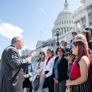 High school students speaking with a Congressman on the steps of the U.S. Capitol in Washington, DC