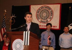 Young American Indian man speaking at podium at USET Ceremony in Washington, DC