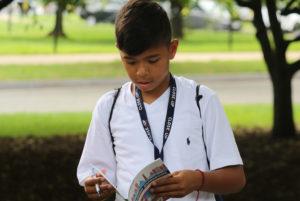 kid reading in dc outside