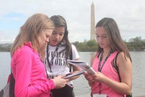 Washington monument DC students reading workbooks
