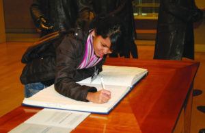 student signing book founding fathers