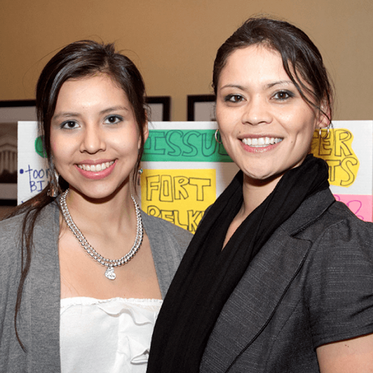 Young American Indian females smiling in front of their tribal proposals