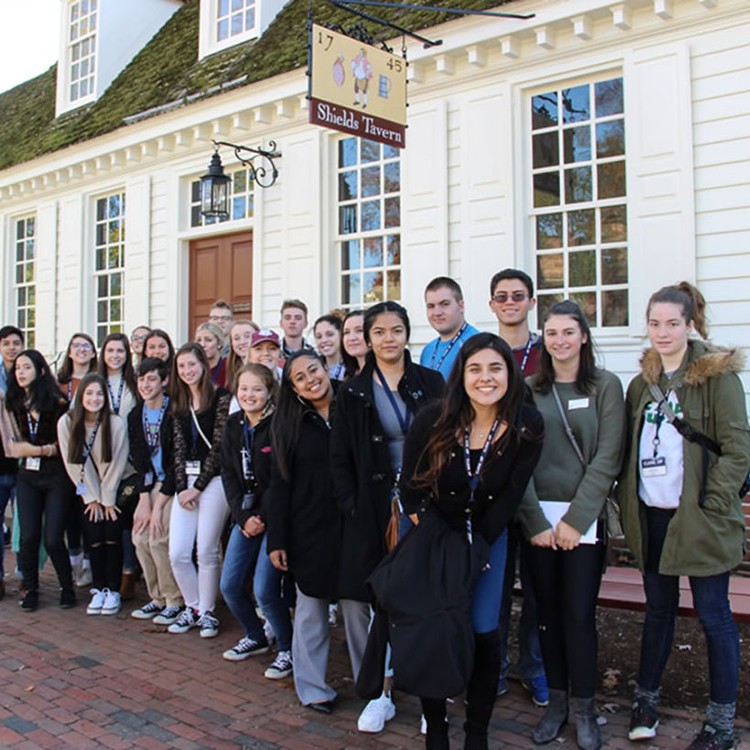 High school students waiting in line in front of Shield's Tavern in Williamsburg, VA