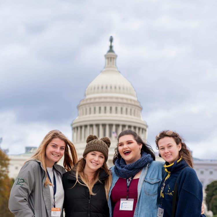 High school girls smiling in front of US Capitol Building