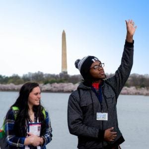 students at tidal basin cherry blossom Washington monument