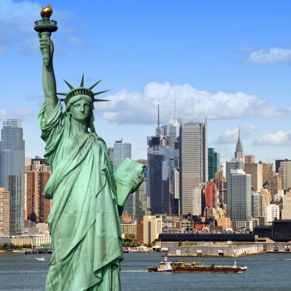 Statue of Liberty and New York City skyline on a sunny day