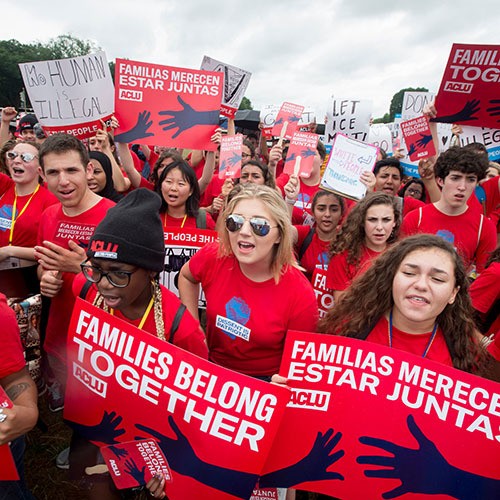 Diverse college students marching with ACLU on National Mall in Washington, DC
