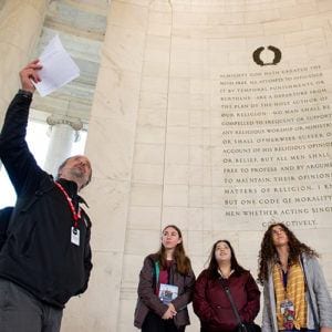Program Instructor speaking with female students at the Thomas Jefferson Memorial in Washington, DC