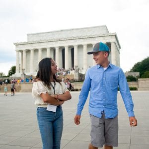 New immigrant and migrant high school male and female talking in front of Lincoln Memorial in Washington, DC
