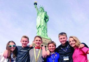 High school students learning about immigration at Statue of Liberty in New York